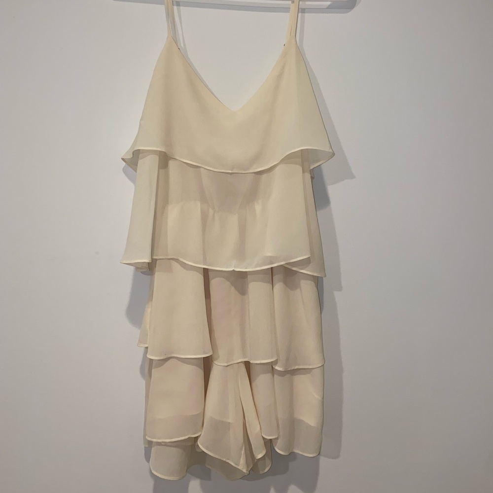 A cream flowy romper, size small